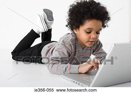 Stock Photography - Boy using laptop. Fotosearch