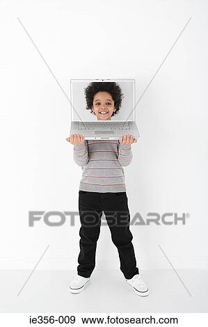 Stock Photo - Boy with face on laptop. Fotosearch