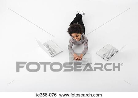 Boy with three laptops View Large Photo Image Stock Photograph - Boy with three laptops. Fotosearch