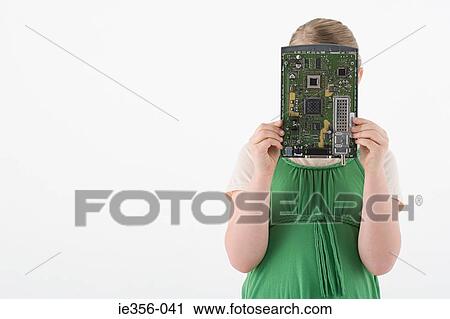 Stock Image - Girl holding circuit board. Fotosearch