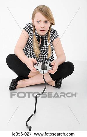 Stock Photo - Girl playing video game. Fotosearch