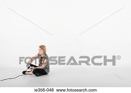Girl playing video game View Large Photo Image Stock Photo - Girl playing video game. Fotosearch