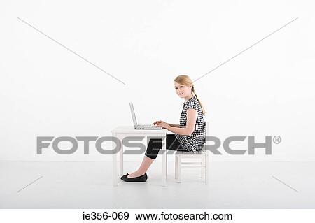 Girl using laptop View Large Photo Image Stock Photo - Girl using laptop. Fotosearch