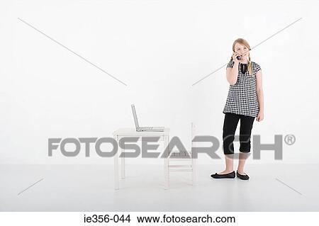 Girl with cellphone and laptop View Large Photo Image Picture - Girl with cellphone and laptop. Fotosearch