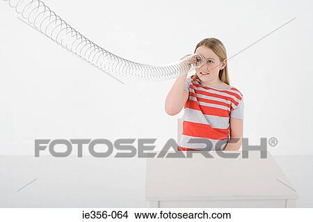 Picture - Girl with metal coil. Fotosearch