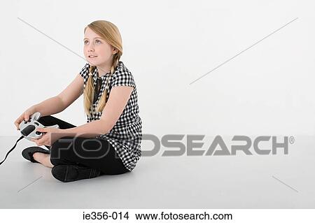 Picture - Girl with video game contoller. Fotosearch