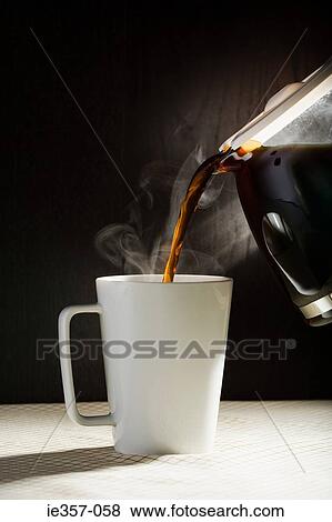 A Cafetiere Pouring Coffee Into Cup A Cafetiere Pouring Coffee Into Cup