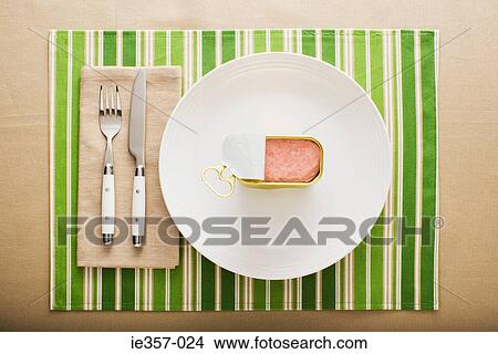 Picture - A can of ham on a plate. Fotosearch