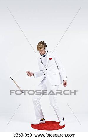 A businessman carrying a briefcase View Large Photo Image Stock Image - A businessman carrying a briefcase. Fotosearch