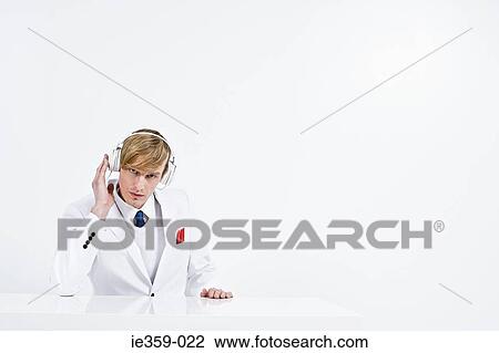 A businessman listening to music View Large Photo Image Stock Image - A businessman listening to music. Fotosearch