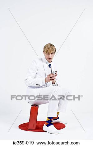A businessman using a cell phone View Large Photo Image Stock Photo - A businessman using a cell phone. Fotosearch