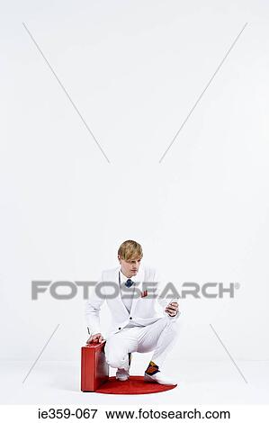 A businessman using a cell phone View Large Photo Image Stock Photo - A businessman using a cell phone. Fotosearch
