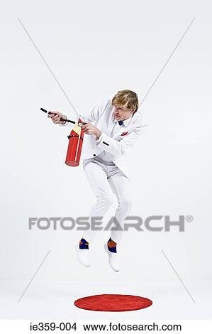 A businessman using a fire extinguisher View Large Photo Image Picture - A businessman using a fire extinguisher. Fotosearch