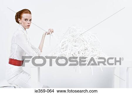 A businesswoman holding shredded paper View Large Photo Image Picture - A businesswoman holding shredded paper. Fotosearch