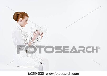 A businesswoman holding shredded paper View Large Photo Image Stock Image - A businesswoman holding shredded paper. Fotosearch