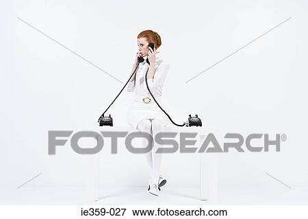 Stock Photo - A businesswoman multitasking. Fotosearch