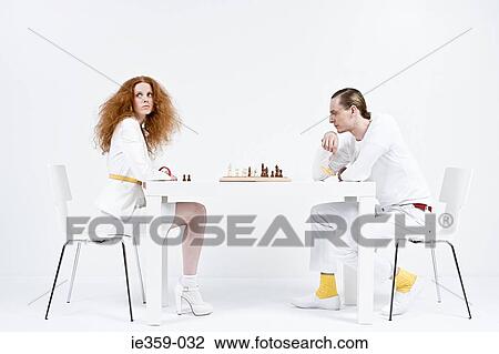 Stock Image - A man and woman playing chess. Fotosearch