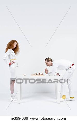 A man and woman playing chess View Large Photo Image Stock Photograph - A man and woman playing chess. Fotosearch