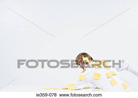 Stock Photo - A man covered in adhesive notes. Fotosearch