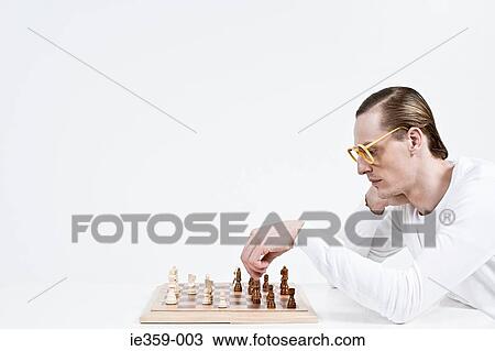 Stock Image - A man playing chess. Fotosearch