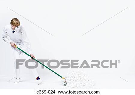 A man sweeping up shredded paper View Large Photo Image Picture - A man sweeping up shredded paper. Fotosearch