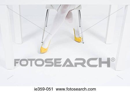 Stock Image - A woman wearing yellow high heels. Fotosearch