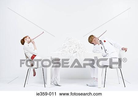 Businesspeople blowing party horns View Large Photo Image Stock Image - Businesspeople blowing party horns. Fotosearch