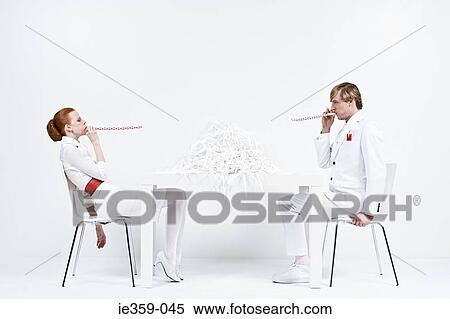 Stock Photography - Businesspeople blowing party horns. Fotosearch