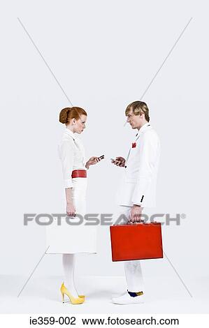 Businesspeople face to face using cell phones View Large Photo Image Stock Image - Businesspeople face to face using cell phones. Fotosearch