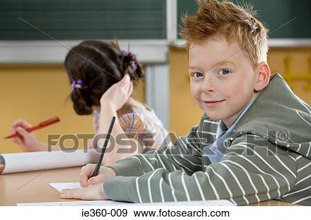 Boy in classroom View Large Photo Image Stock Photo - Boy in classroom. Fotosearch