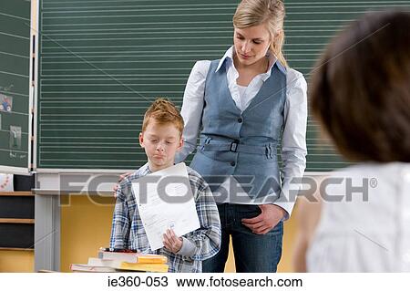 Boy looking sad in classroom View Large Photo Image Stock Image - Boy looking sad in classroom. Fotosearch