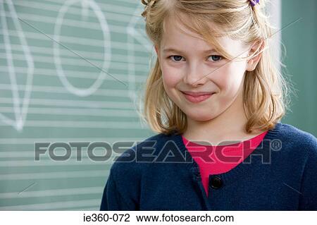 Stock Image - Girl in classroom. Fotosearch