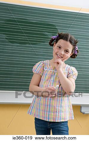Stock Photo - Girl in classroom. Fotosearch