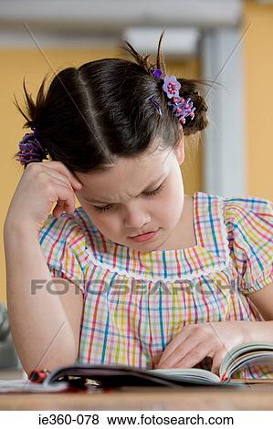 Girl struggling with reading View Large Photo Image Stock Photo - Girl struggling with reading. Fotosearch