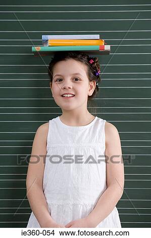 Girl with books on her head View Large Photo Image Picture - Girl with books on her head. Fotosearch