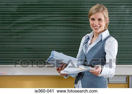 Stock Image - Teacher with textbooks. Fotosearch