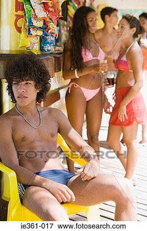 A teenage boy sat on a chair View Large Photo Image Stock Photo - A teenage boy sat on a chair. Fotosearch