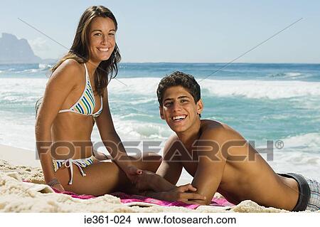 Picture - A teenage couple on the beach. Fotosearch