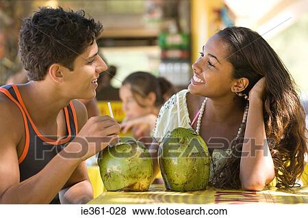 A teenage couple sat in a bar View Large Photo Image Stock Photo - A teenage couple sat in a bar. Fotosearch