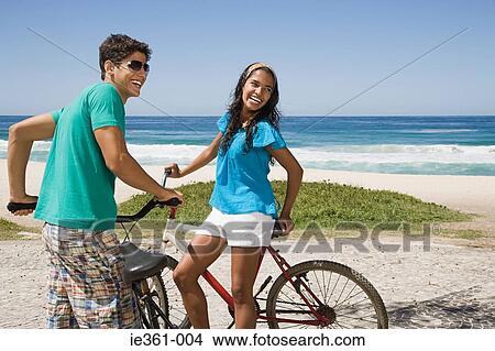 A teenage couple with bikes View Large Photo Image Picture - A teenage couple with bikes. Fotosearch