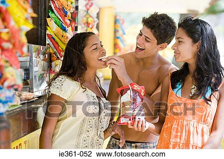 Friends eating crisps View Large Photo Image Stock Image - Friends eating crisps. Fotosearch