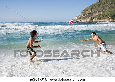 Teenage boys playing with a football View Large Photo Image Stock Photograph - Teenage boys playing with a football. Fotosearch