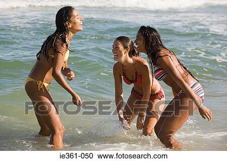 Teenage girls playing in the sea View Large Photo Image Stock Image - Teenage girls playing in the sea. Fotosearch