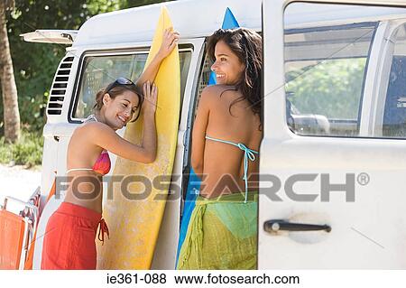 Stock Photo - Teenage girls with surboards. Fotosearch