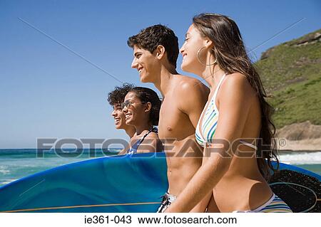 Teenagers carrying surfboards View Large Photo Image Stock Image - Teenagers carrying surfboards. Fotosearch