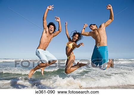 Stock Image - Teenagers jumping. Fotosearch