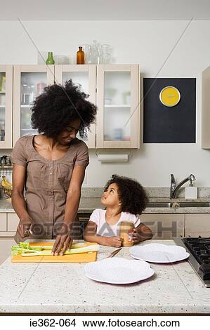 A daughter helping her mother in the kitchen View Large Photo Image Picture - A daughter helping her mother in the kitchen. Fotosearch