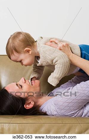 A mother holding her baby View Large Photo Image Stock Image - A mother holding her baby. Fotosearch