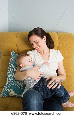 A mother holding her baby View Large Photo Image Stock Photograph - A mother holding her baby. Fotosearch