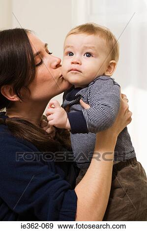 A mother kissing her son View Large Photo Image Stock Photo - A mother kissing her son. Fotosearch